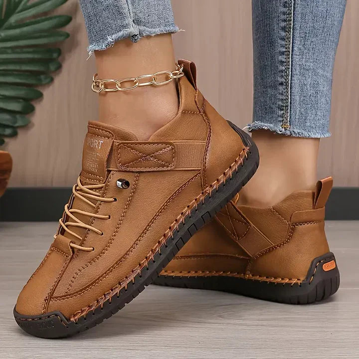 Detail of the durable laces and eyelets on women's supportive walking shoes.