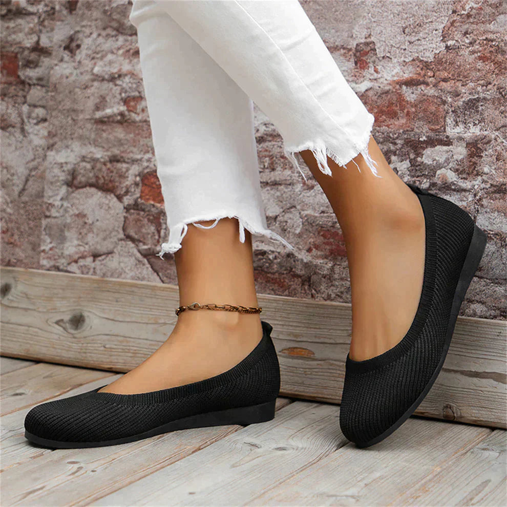 Side view of a women's ballet flat in a classic pastel color, emphasizing comfort.