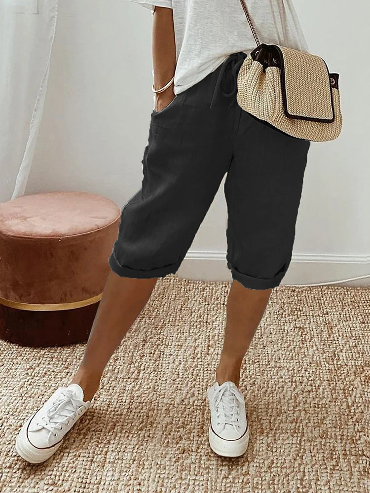 Women's cotton capri pants with drawstring waist & stylish roll hem. Perfect for casual summer comfort.
