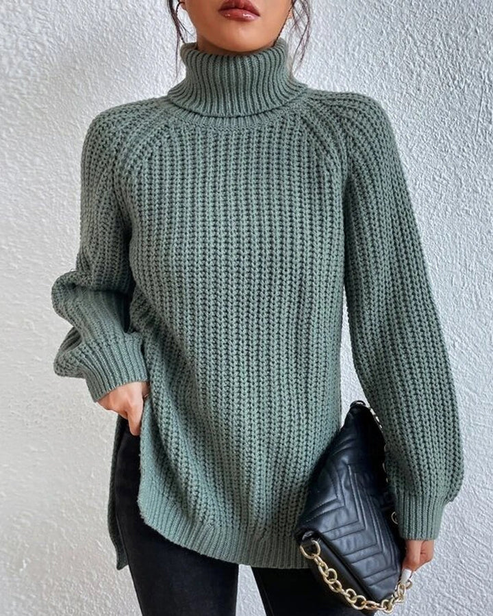 Stack of folded women's ribbed knit winter sweaters in various colors, ready for cold weather.
