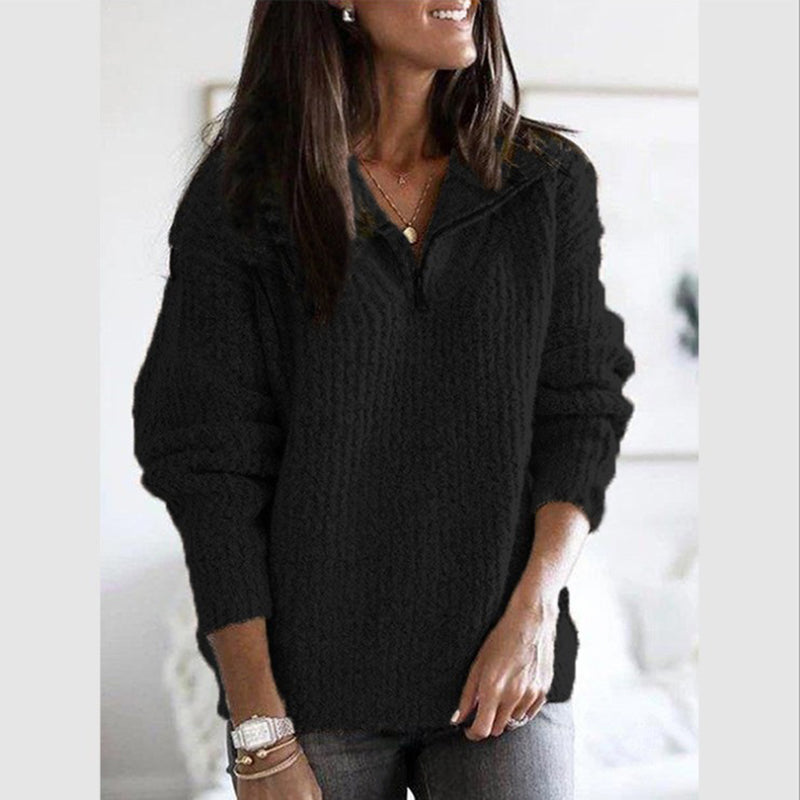Close-up of the textured ribbed fabric on a women's zip-up sweater, cozy and soft feel.