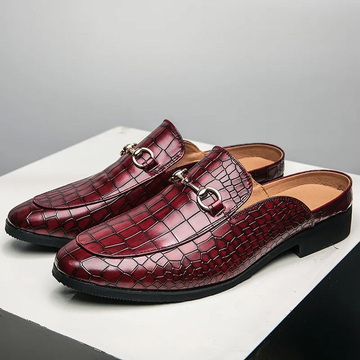 Close-up of women's croc-embossed slip-on loafer mules, highlighting the intricate texture detail