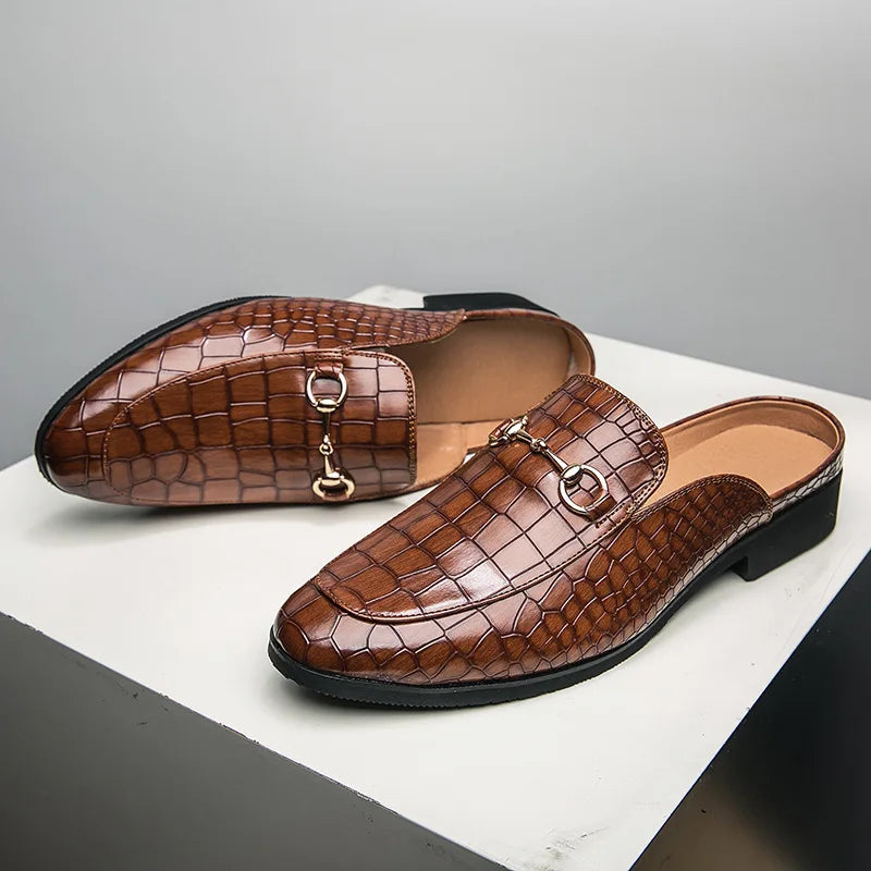 Pair of women's black croc-embossed slip-on loafer mules, a versatile addition to any wardrobe