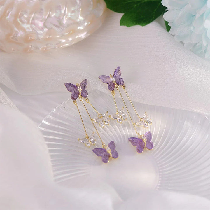 Artistic shot of women's crystal butterfly tassel dangle earrings, showcasing their unique movement