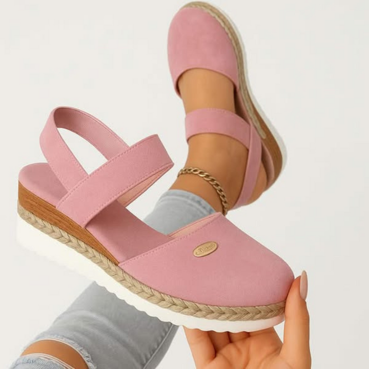Side view of women's slip-on orthopedic sandals with thick cushioning & arch support for stable walking.