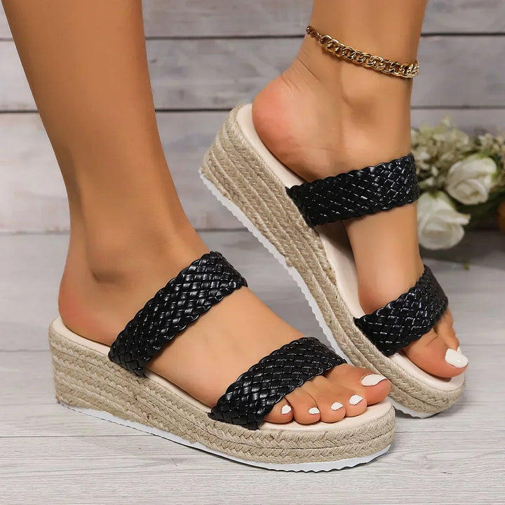 Comfortable slip-on black wedge sandals for women, designed for all-day wear and style.