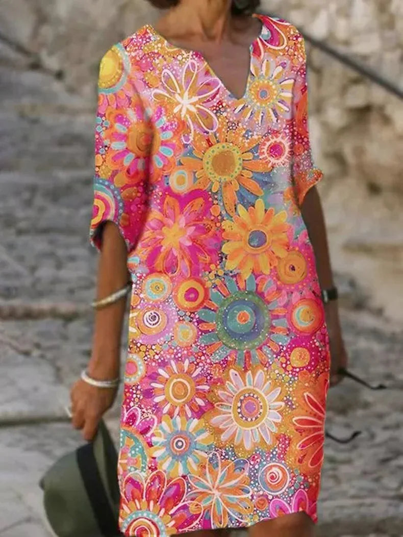 Stylish women's knee-length floral print summer dress with a flattering V-neck, great for day wear or vacation.