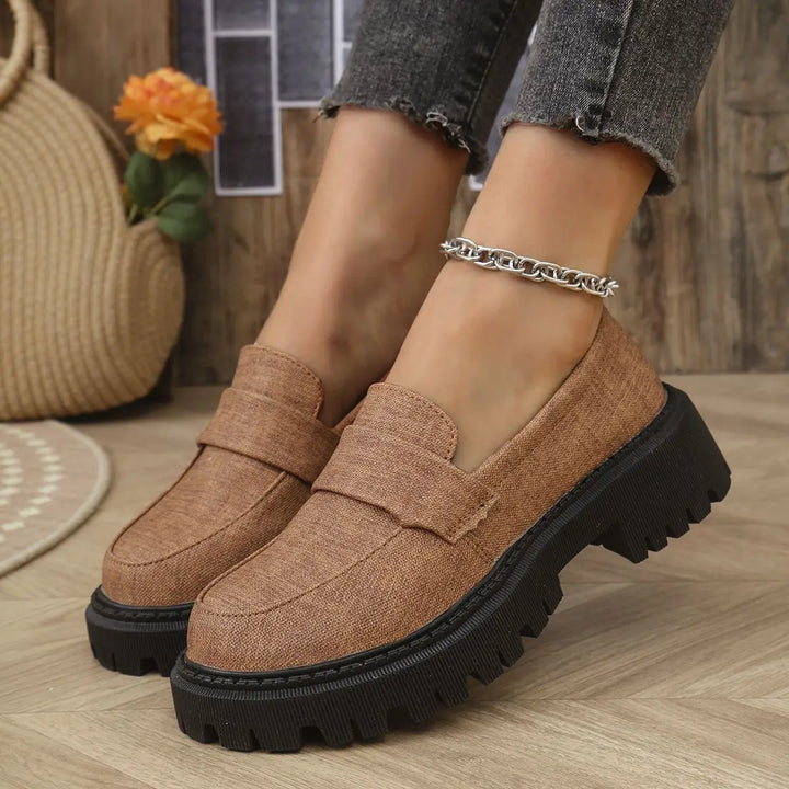 Top-down view of women's denim platform loafers, showcasing the classic loafer silhouette and denim fabric