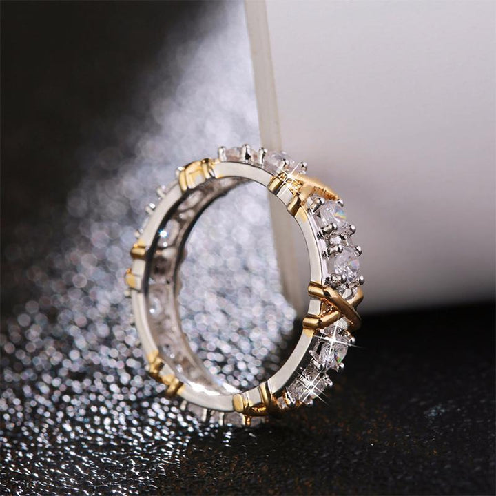 Close-up of a women's dichroic zircon engagement ring on hand