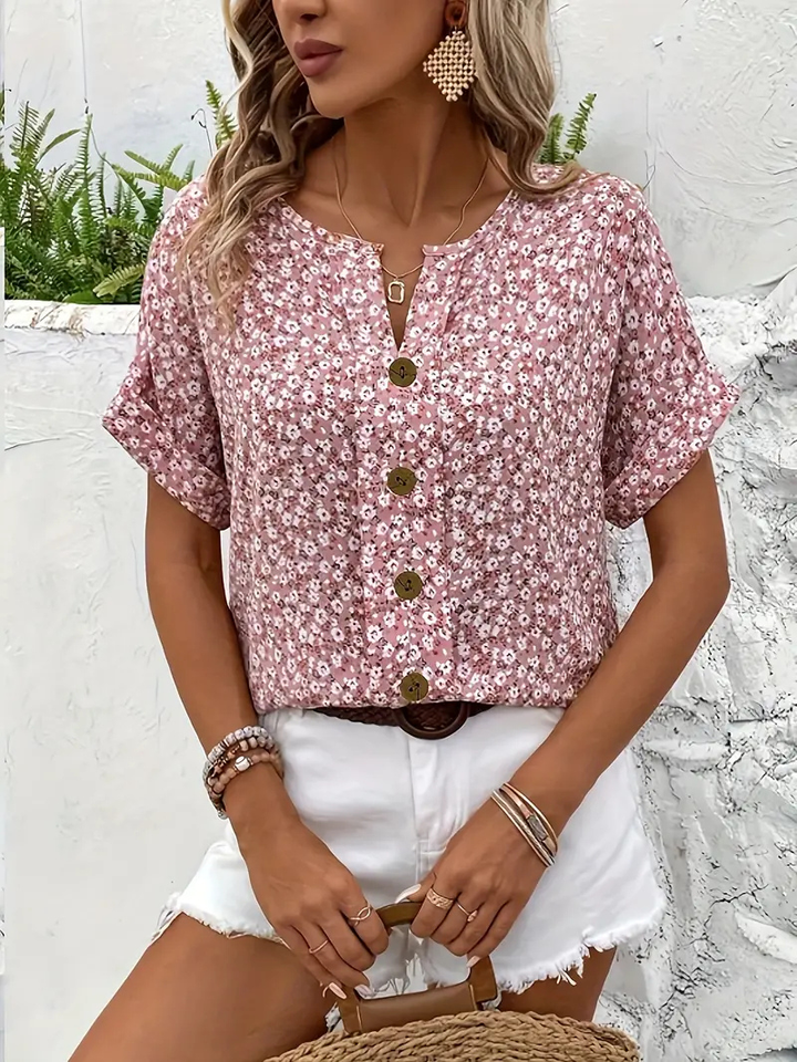 Feminine ditsy floral print women's blouse with button front, ideal for warm weather and spring fashion.