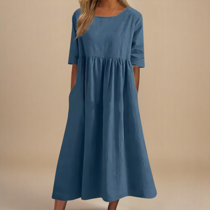 Casual women's half-sleeve midi dress with a chic gathered empire waist, scoop neck, and convenient pockets.