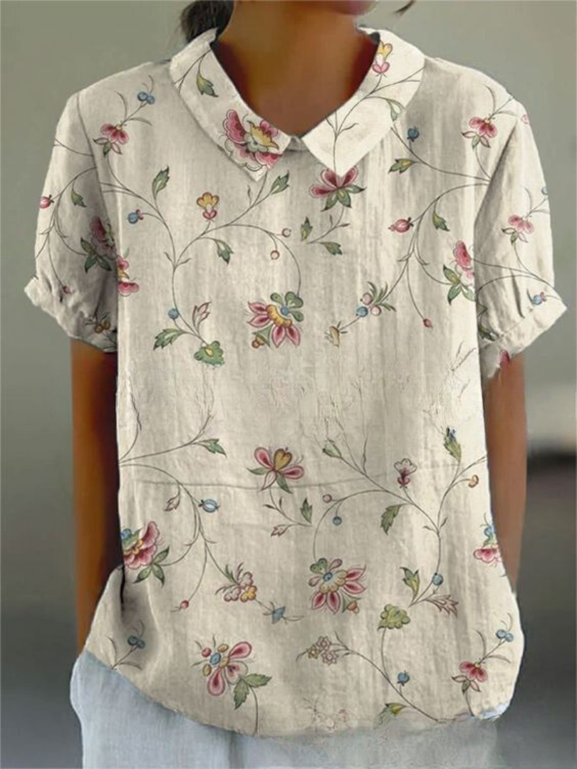 Feminine short sleeve floral embroidered blouse with unique Peter Pan collar, a casual chic summer top.