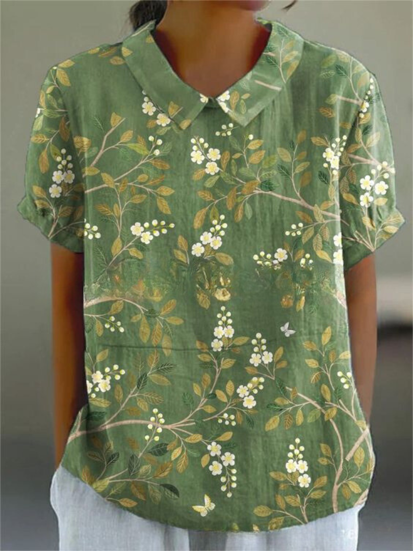 Women's versatile floral embroidered blouse featuring a delicate Peter Pan collar and short sleeves.