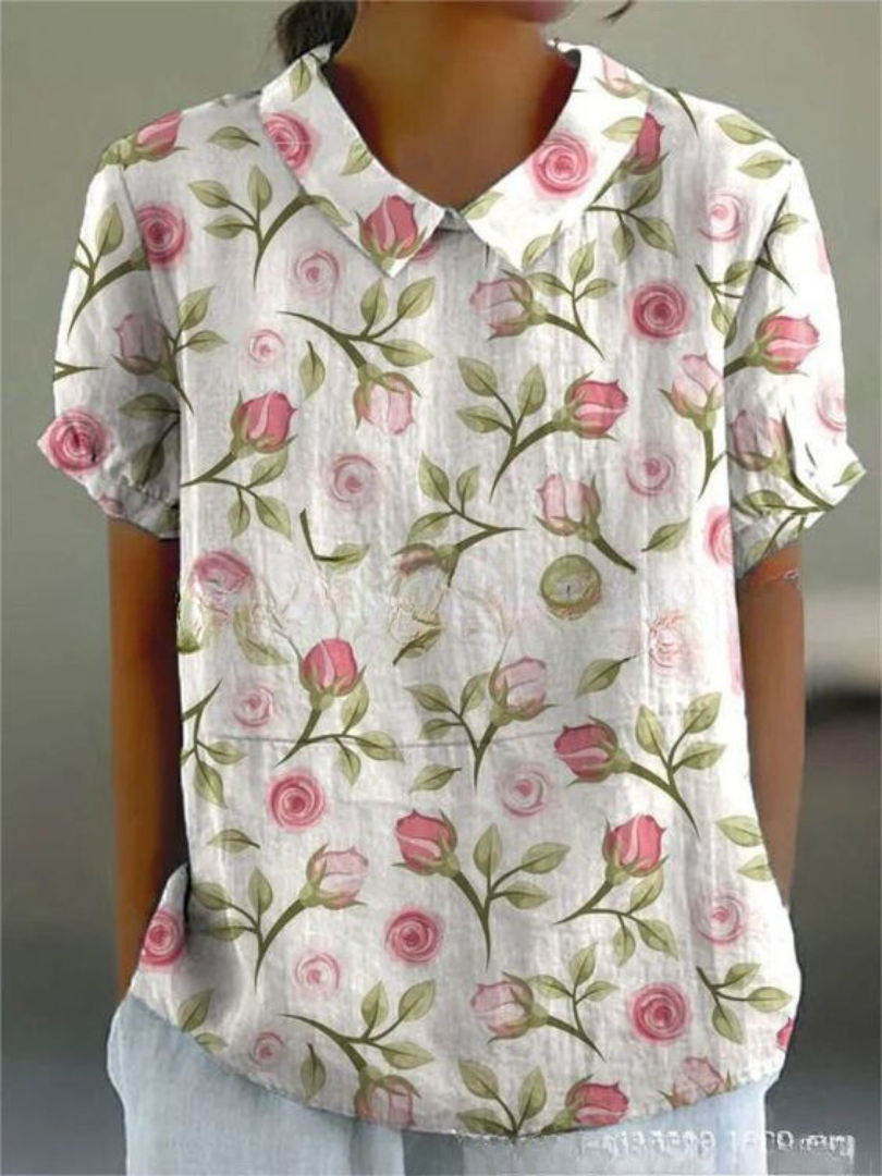 Vintage style women's blouse with delicate floral embroidery & classic Peter Pan collar, feminine spring fashion.