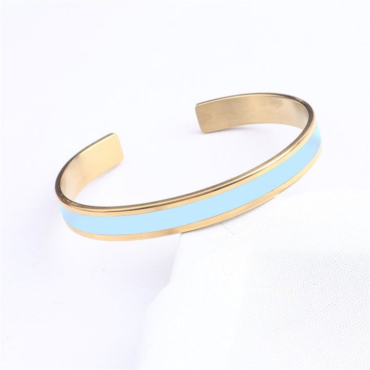 Artistic shot of a women's stainless steel bangle, engraved with a floral motif, unique jewelry