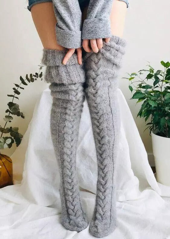 Stylish women's extra long knitted over-knee socks, ideal for layering and warmth in winter clothing.
