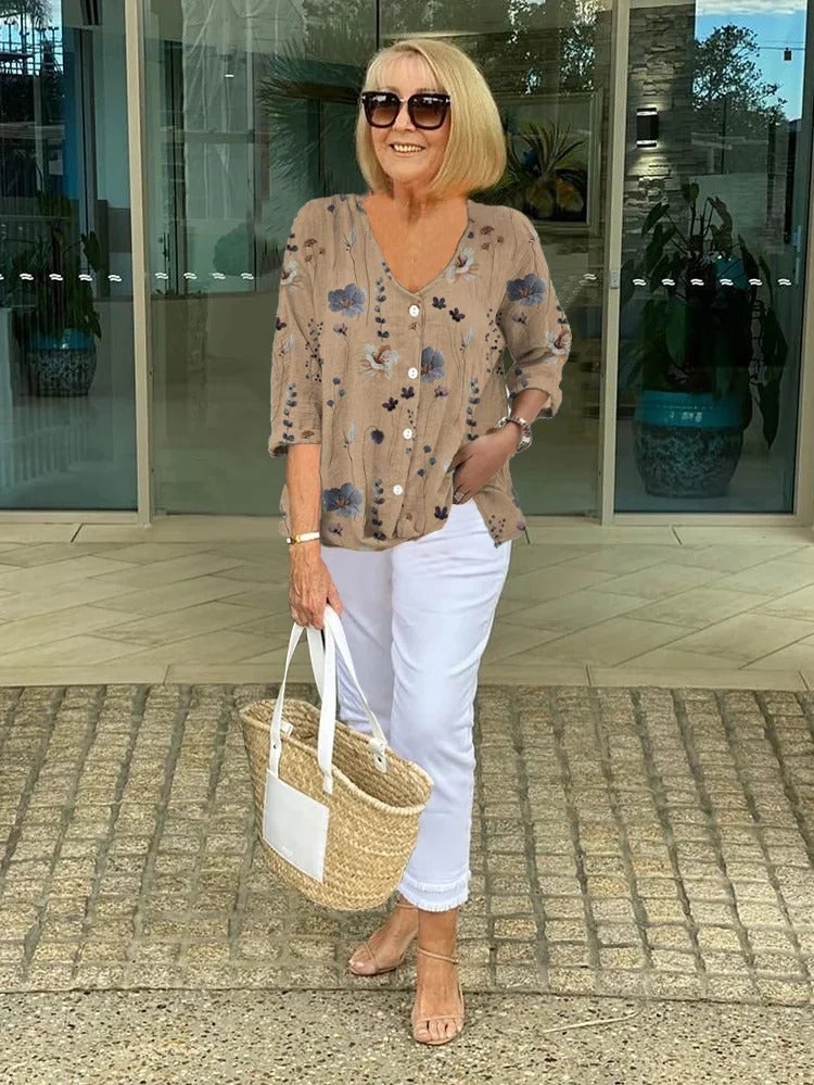 Elegant women's floral blouse, V-neck, button-front. Stylish three-quarter sleeve top for office or everyday.