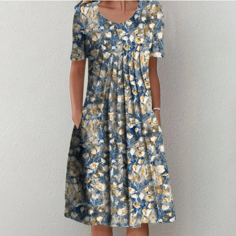 Comfortable loose-fit women's floral midi dress with pockets, short sleeve, ideal for everyday spring/summer wear.
