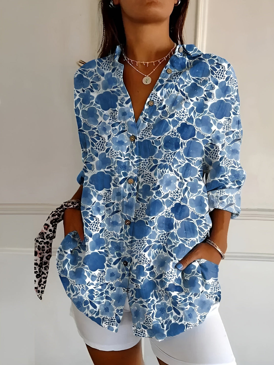 Women's floral print oversized button-down blouse, a stylish choice for casual summer fashion.
