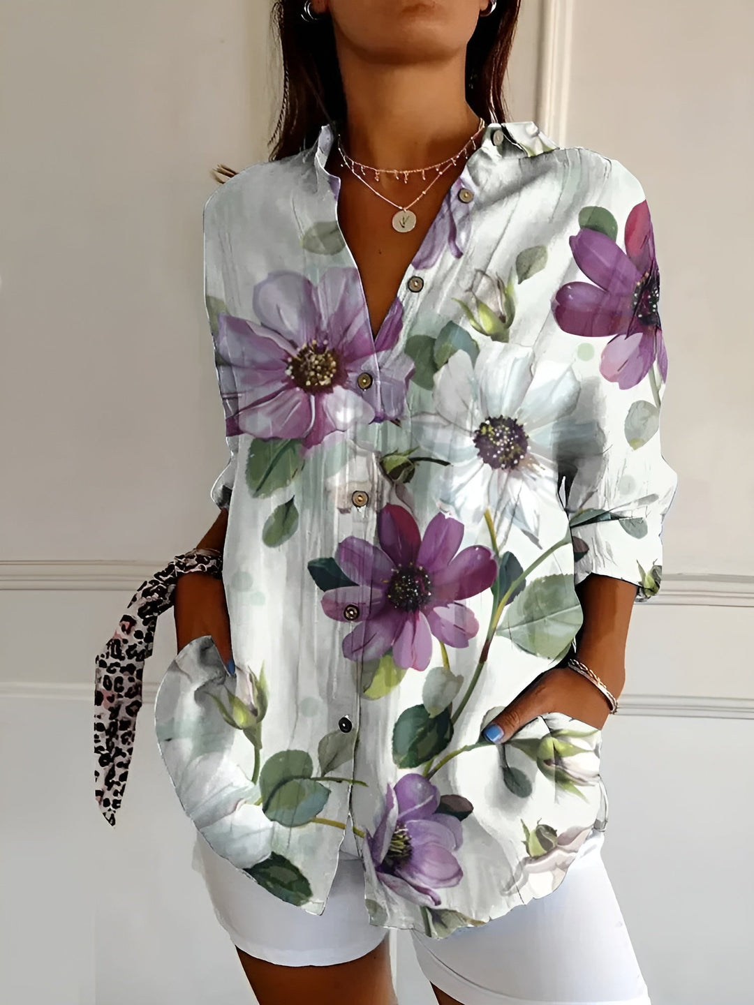 Chic women's oversized button-down blouse featuring an all-over floral vine print. Relaxed summer clothing.