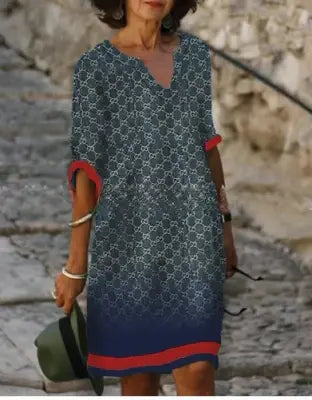 Artistic face print detail on the bodice of a women's floral V-neck midi dress