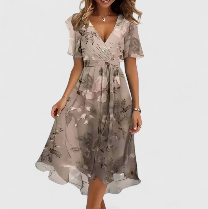 Flowy women's floral V-neck midi dress with elegant flutter sleeves, perfect for spring fashion.