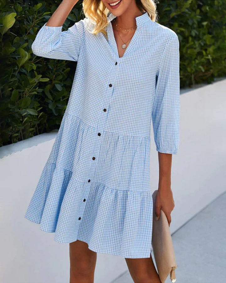 Women's flowy A-line summer dress with a chic check pattern. Perfect casual midi dress for stylish everyday wear.