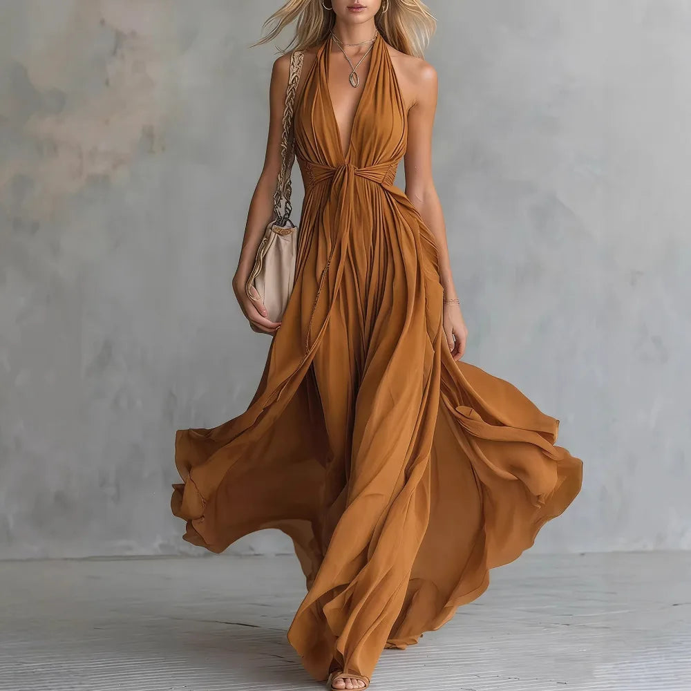 Sophisticated women's long evening dress with a pleated halter and backless style. A flowy maxi gown for special events.