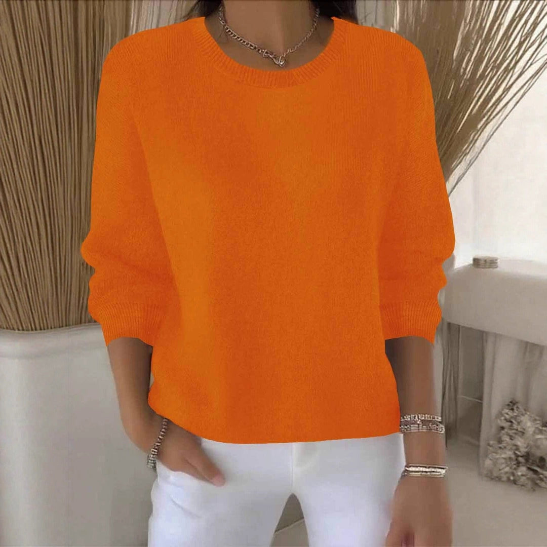 Woman modeling a flowy relaxed fit sweater, showcasing versatile casual chic autumn style.