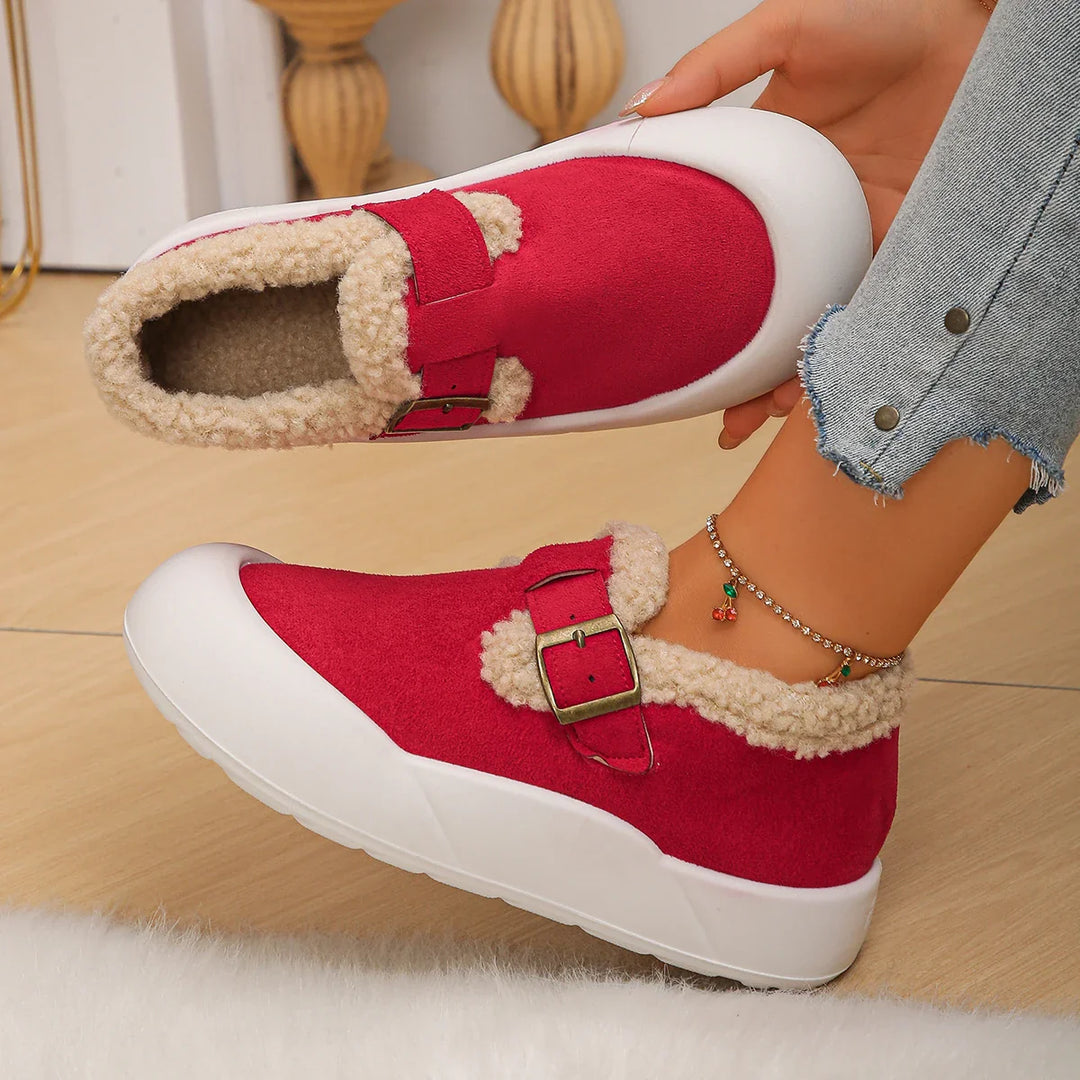 Stylish women's brown leather clogs, fleece-lined for warmth, with a prominent buckle design.