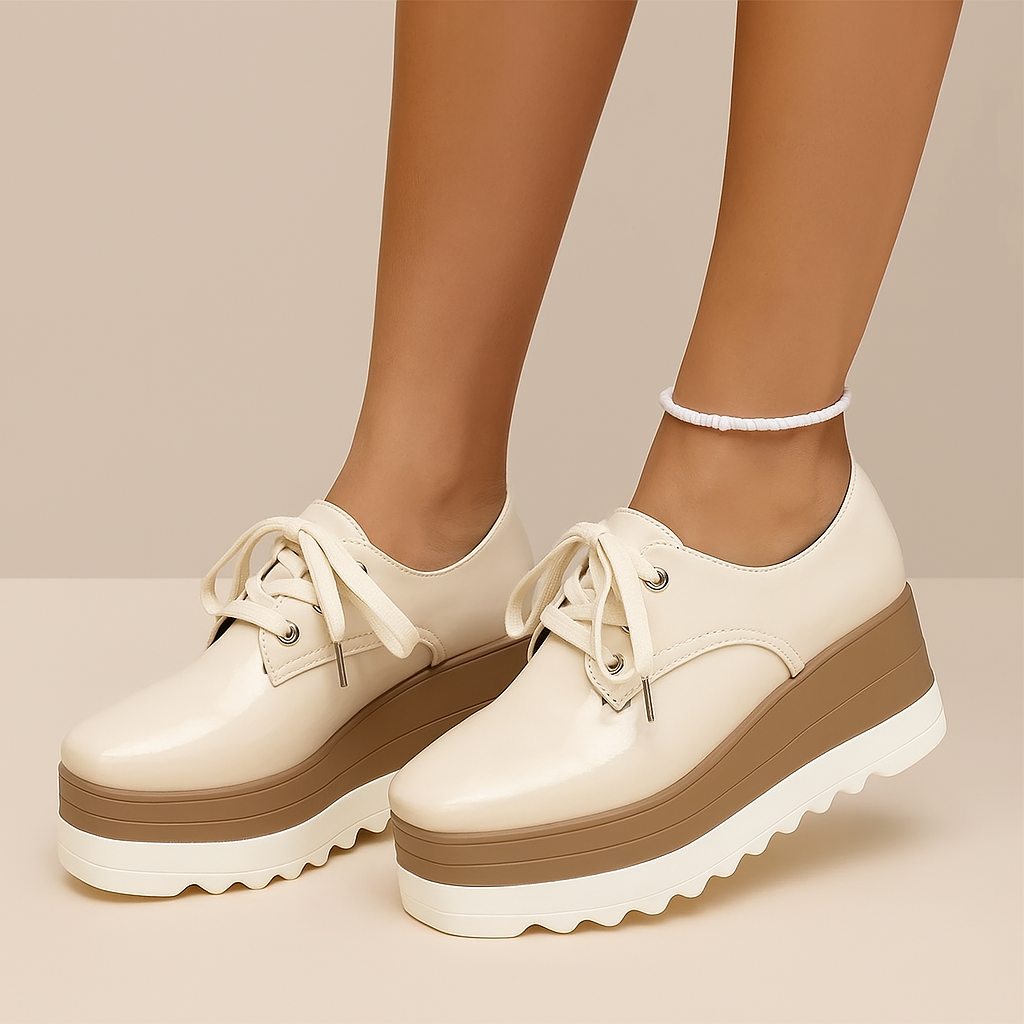 Women's glossy black platform sneakers with white soles, side view, ideal for casual wear and comfort.