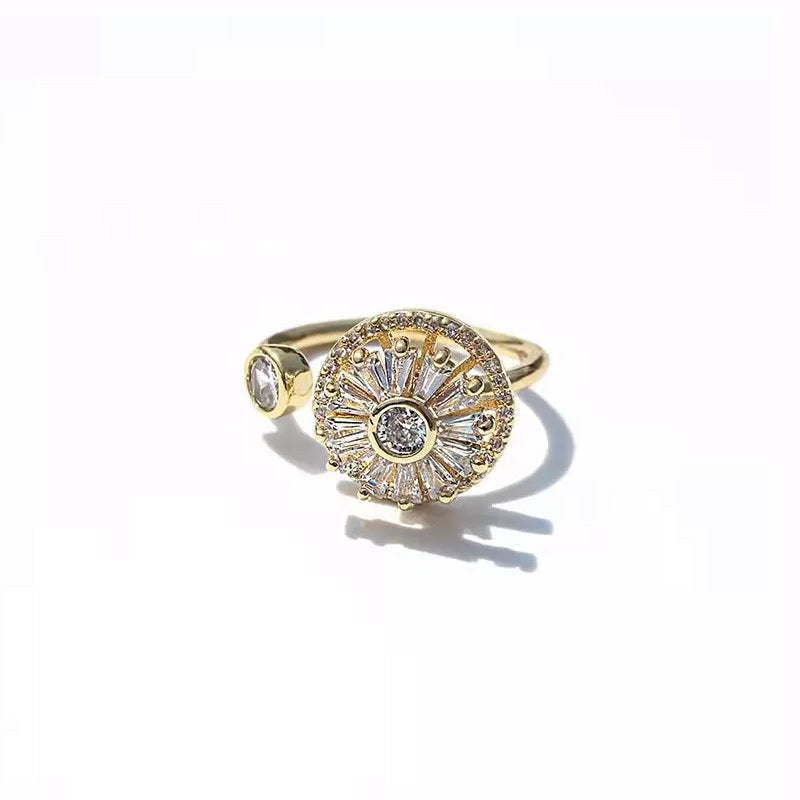 Stylish women's anxiety relief spinner ring with gold finish and embedded crystals, adjustable fit.