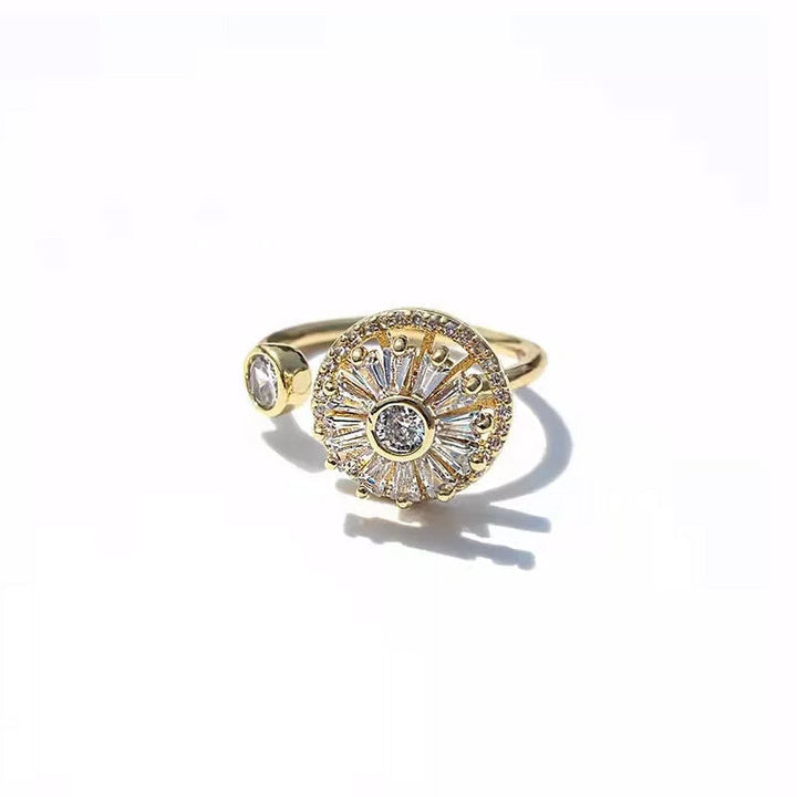 Stylish women's anxiety relief spinner ring with gold finish and embedded crystals, adjustable fit.