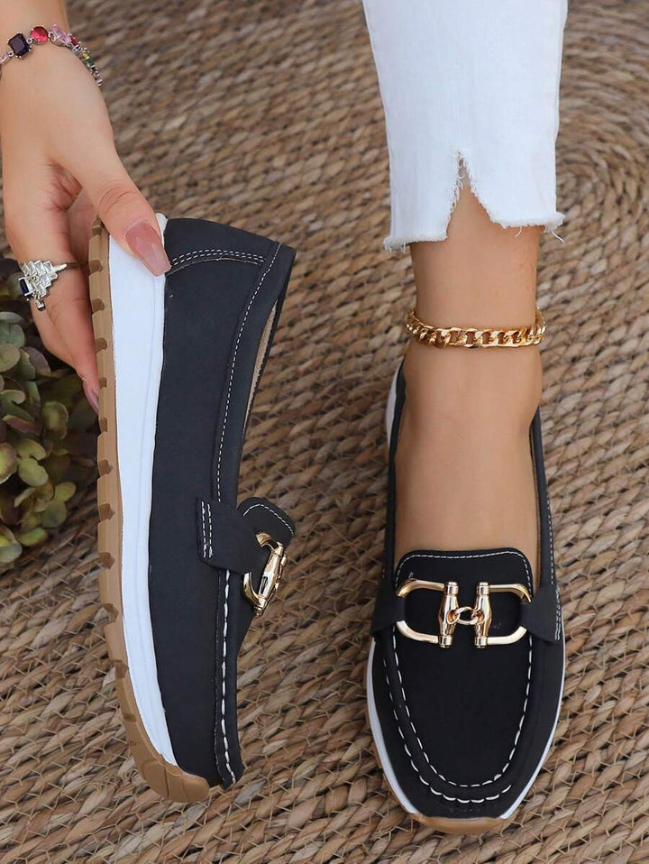 Navy women's horsebit loafers with gold trim, elegant and comfortable professional flats.