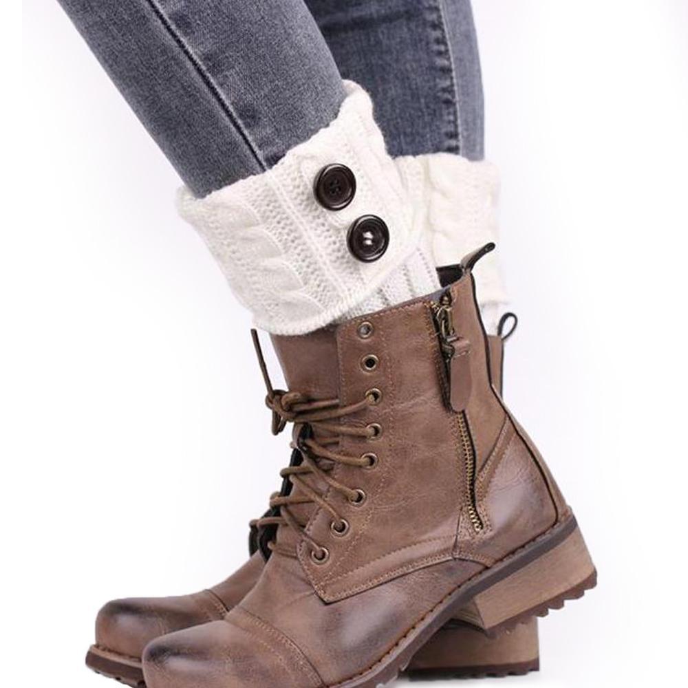Detail of a women's acrylic knit boot topper, intricate cable knit pattern and buttons