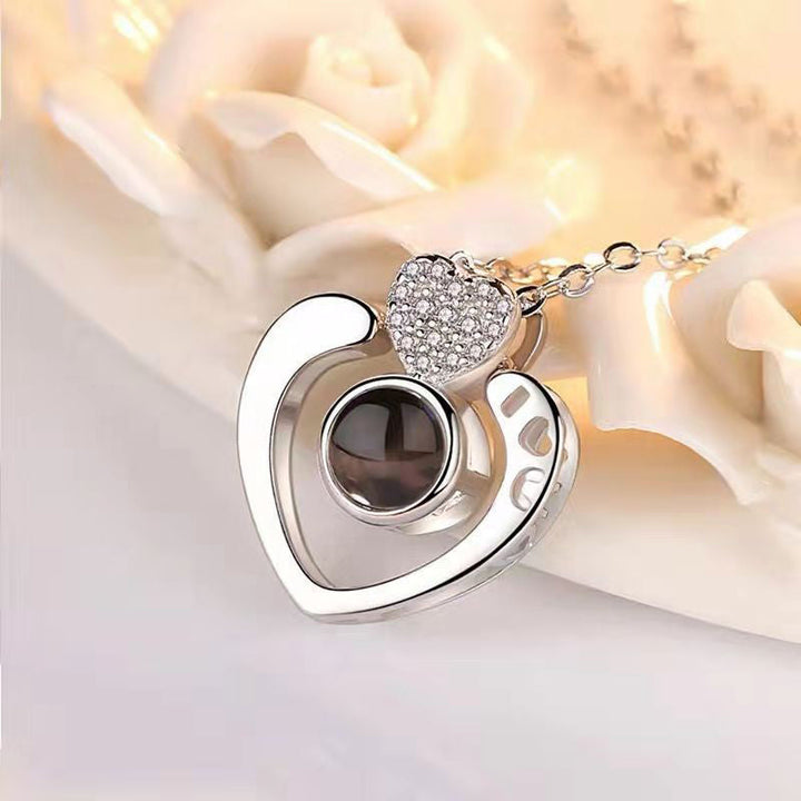Rose gold '100 Languages I Love You' heart pendant, a romantic and intricate piece of women's jewelry.