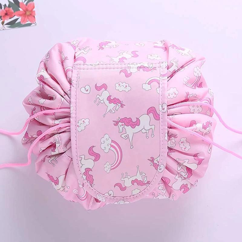 Women's travel makeup pouch, made from durable oxford cloth, unrolled on a hotel counter with essentials.