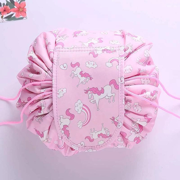 Women's travel makeup pouch, made from durable oxford cloth, unrolled on a hotel counter with essentials.