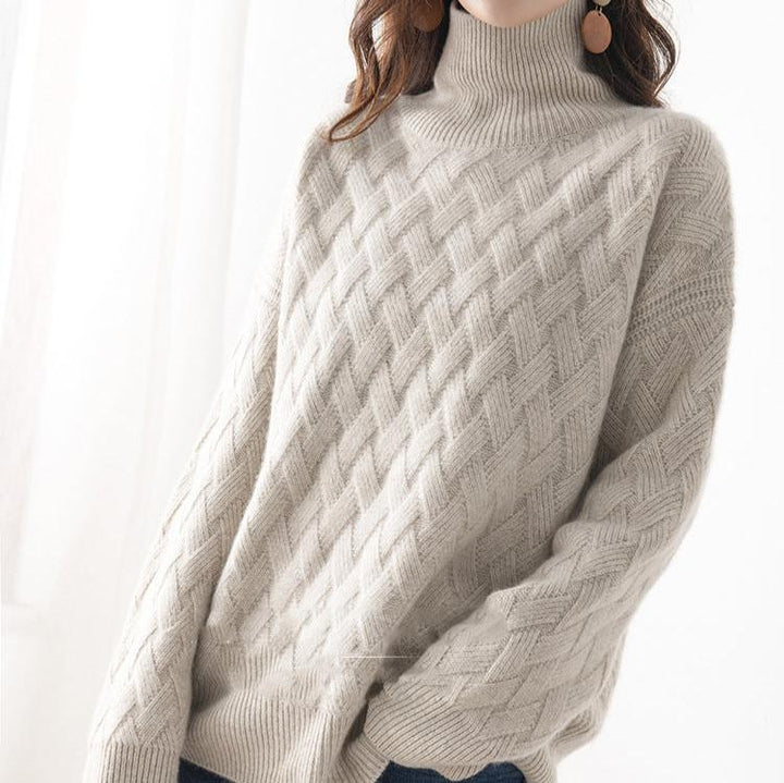 Close-up of a women's soft pink lightweight turtleneck sweater, showcasing fine knitwear detail.