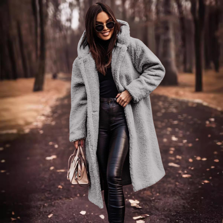 Cozy women's teddy bear long coat with a hood, offering ultimate warmth and a stylish look for winter.