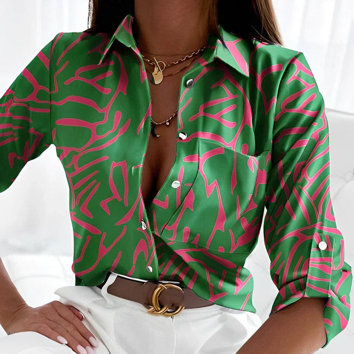 Women's long sleeve button-down blouse with abstract print. Stylish collared top for work or casual wear.