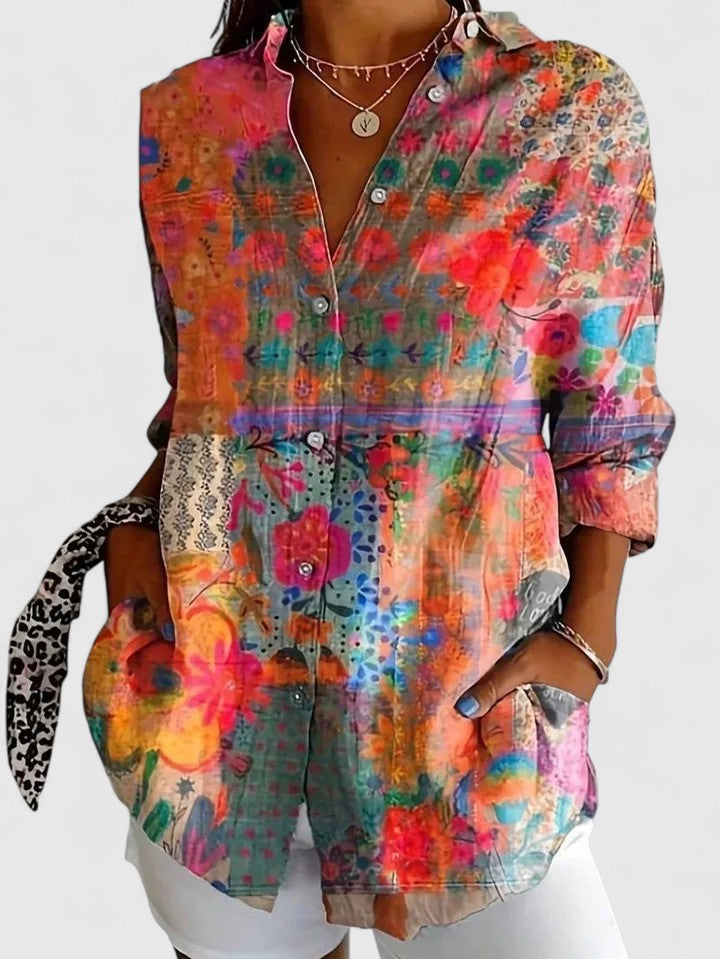 Stylish women's collared blouse with vibrant abstract floral print. Perfect for casual spring and summer looks.