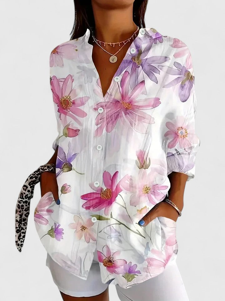 Fashionable women's long sleeve collared blouse in a vibrant abstract floral pattern. Spring/summer style.