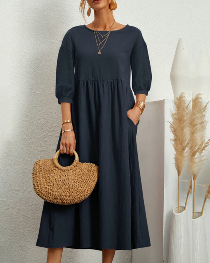 Sophisticated women's midi dress with round neckline and dramatic lantern sleeves for an elegant touch.