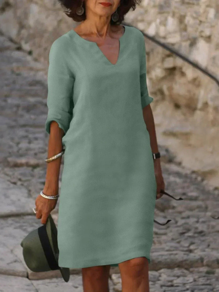 Versatile women's V-neck mini dress with 3/4 sleeves, a chic casual choice for any season.