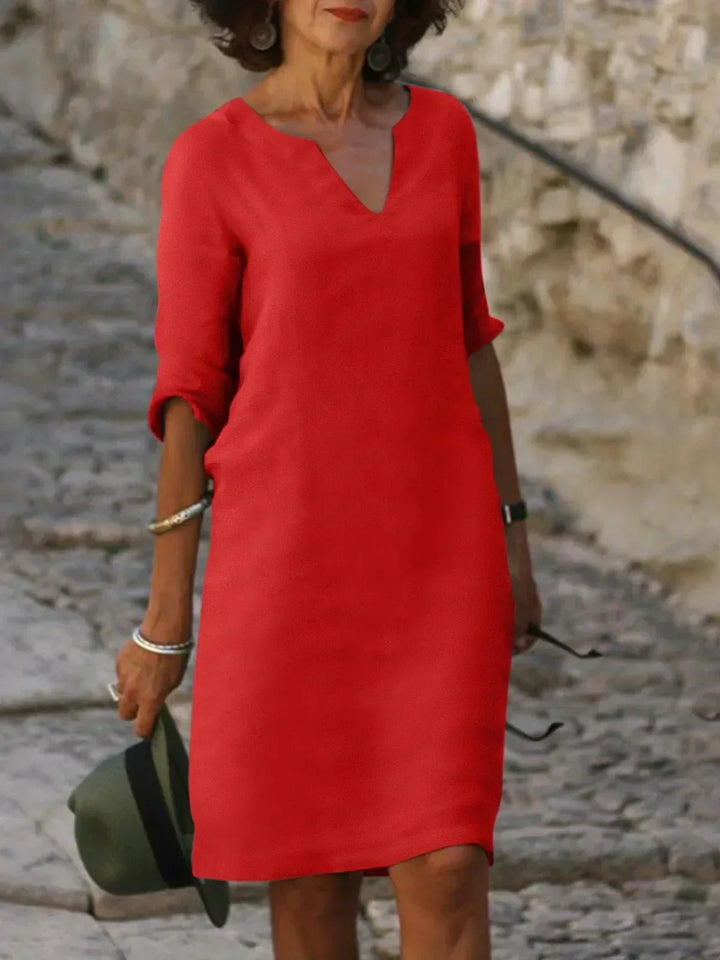 Minimalist women's mini dress, 3/4 sleeve V-neck design, perfect for a relaxed yet chic look.