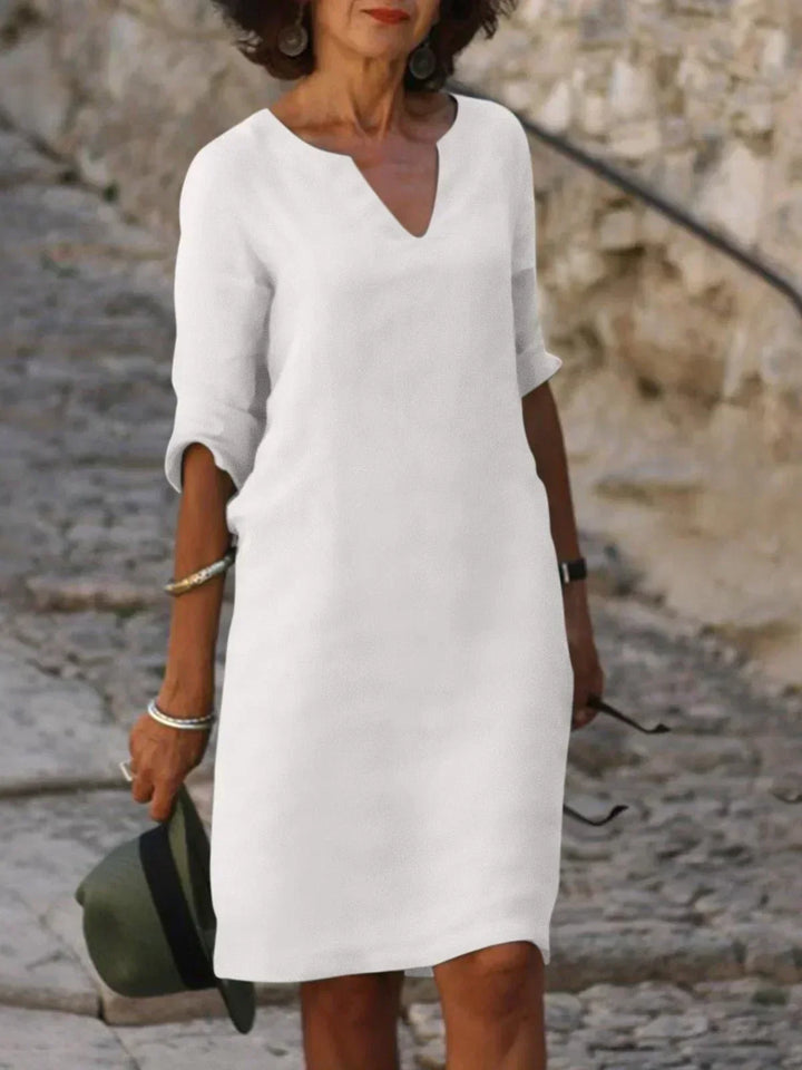 Casual elegant women's mini dress with flowy 3/4 sleeves & V-neck, suitable for daily wear.