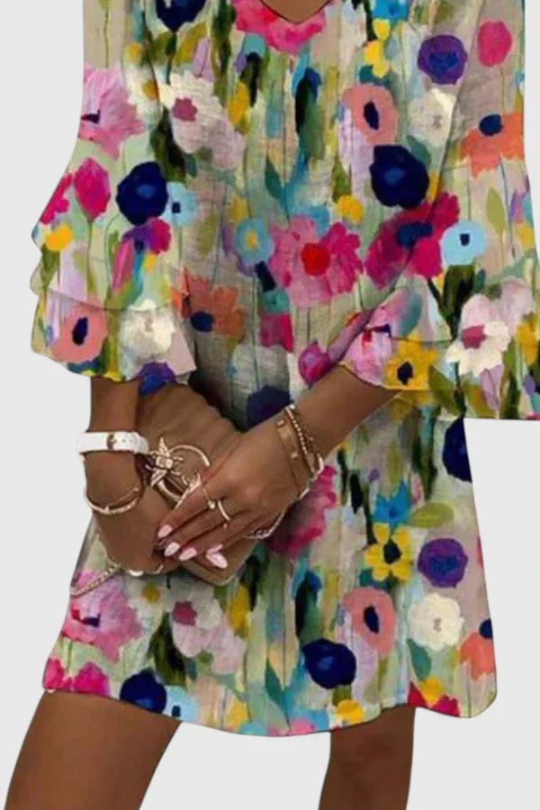 Chic women's floral mini dress with v-neck and ruffled sleeves, ideal for a stylish summer casual look.
