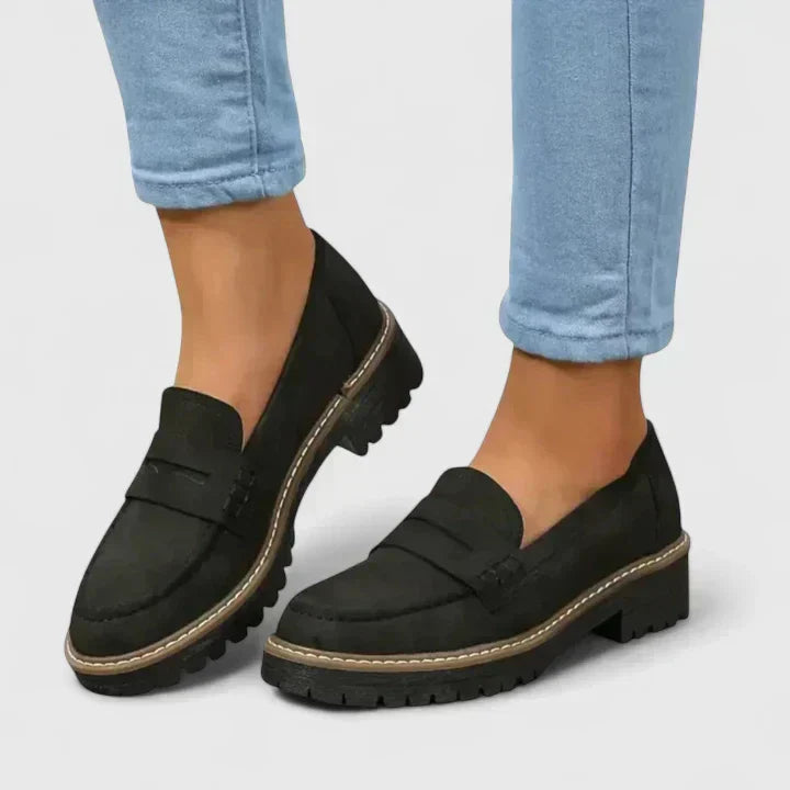 Women's orthopedic comfort loafers in black, offering foot support for everyday walking and work.