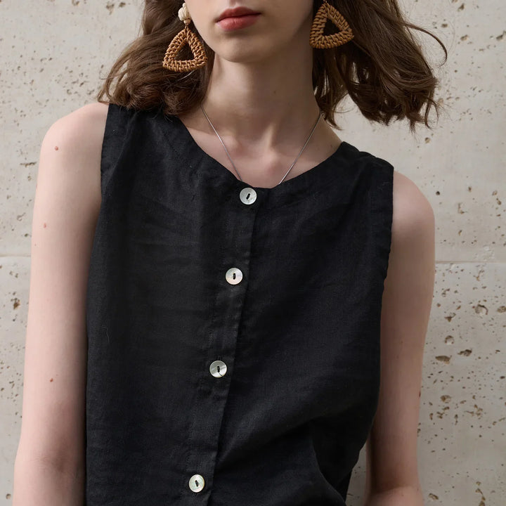 Chic women's sleeveless crop top in pink, showcasing an asymmetric hem and crew neck for summer.